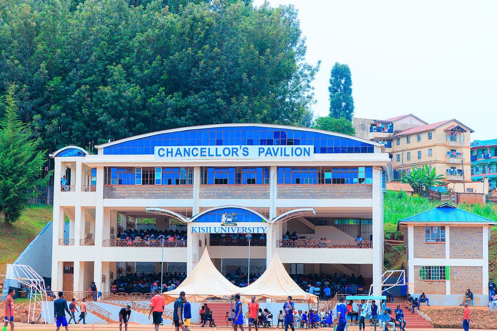 Students gathered on the field in front of the Chancellor's Pavilion at Kisii University