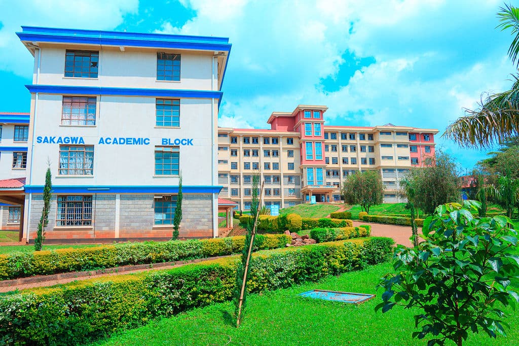 The Sakagwa Academic Block at Kisii University, fronted by clipped hedges and lawns with the teaching blocks rising behind